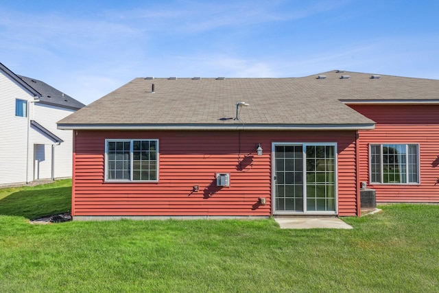 rear view of property with a lawn and central AC unit