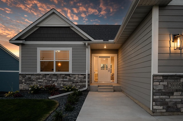 view of exterior entry at dusk