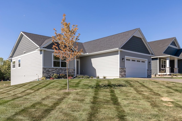 craftsman inspired home with a garage and a front lawn