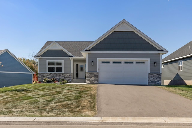 craftsman house with a garage and a front lawn