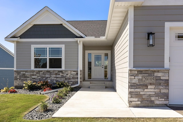 entrance to property with a garage and a yard