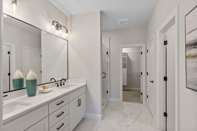 bathroom featuring walk in shower, a textured ceiling, and vanity