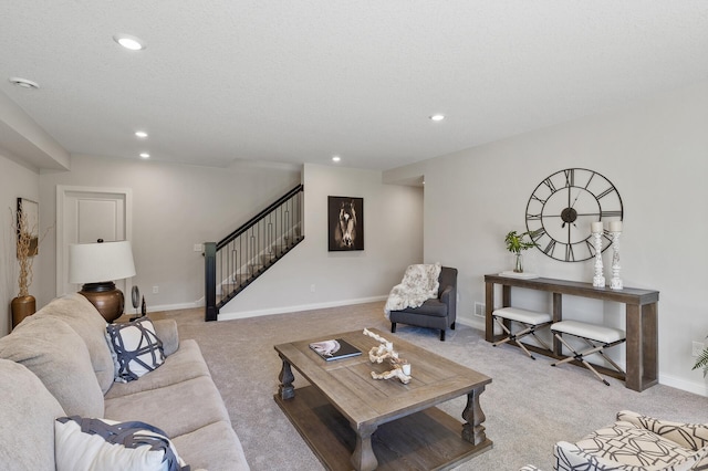 carpeted living room featuring a textured ceiling