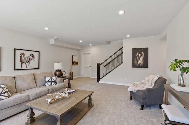 living room featuring light carpet and a textured ceiling