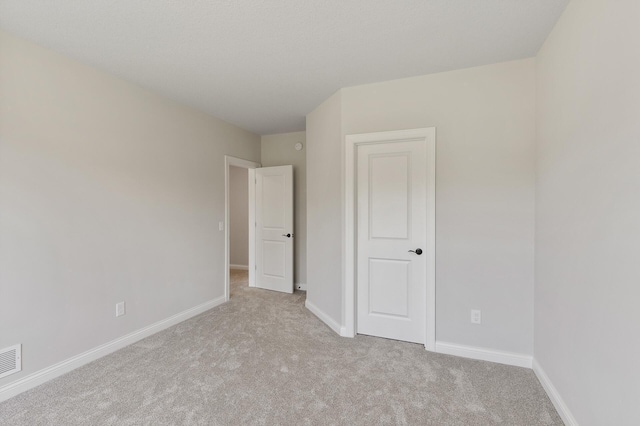 unfurnished bedroom with light carpet