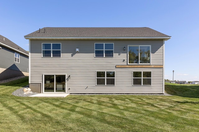 rear view of property featuring a yard and a patio area