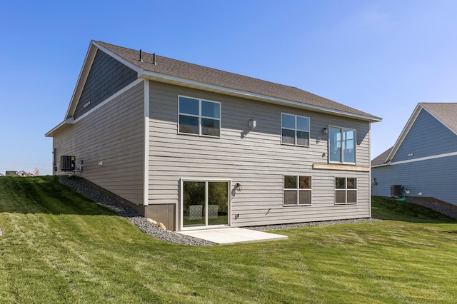 back of property featuring central AC unit, a patio area, and a yard