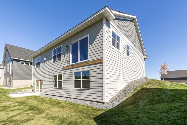 rear view of house featuring a lawn