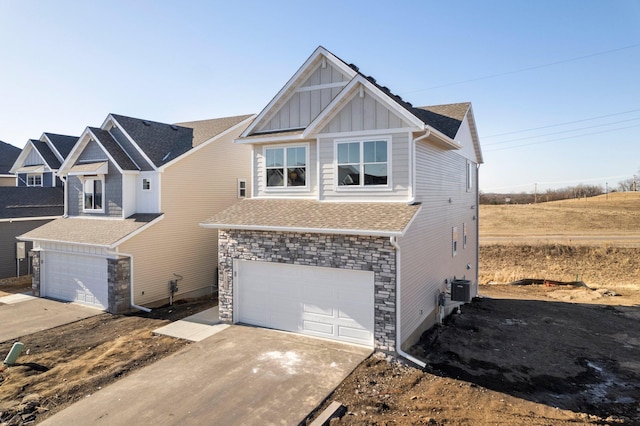 view of front of house with a garage and central AC