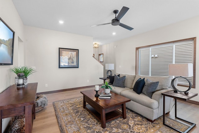 living room featuring light hardwood / wood-style floors and ceiling fan