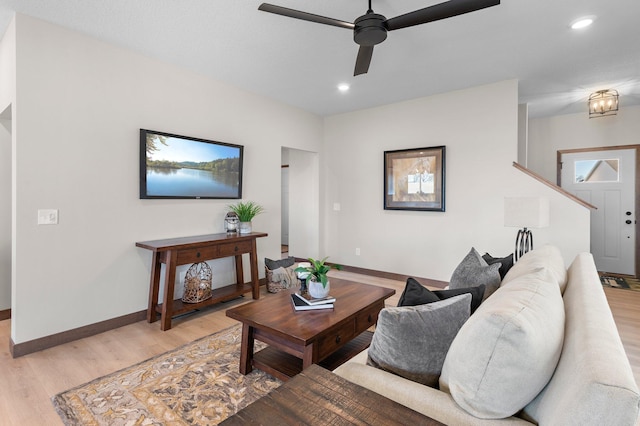 living room with ceiling fan and light wood-type flooring