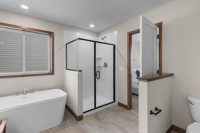 bathroom with shower with separate bathtub, a textured ceiling, and toilet