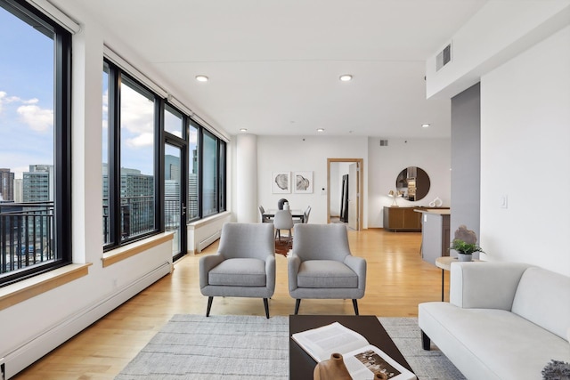 living room featuring light hardwood / wood-style floors and a baseboard radiator