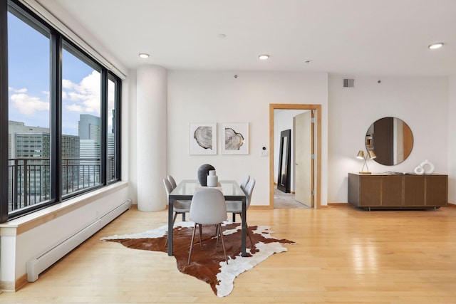 dining area featuring light hardwood / wood-style floors and baseboard heating