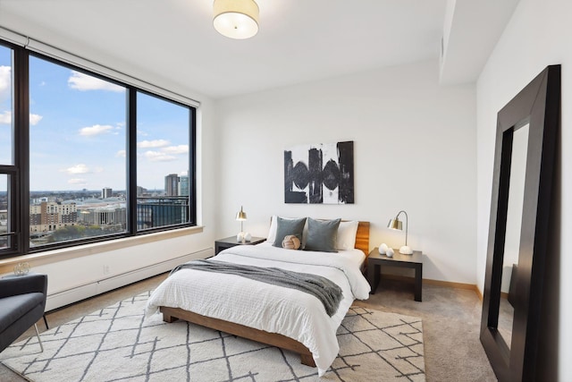 carpeted bedroom featuring baseboard heating