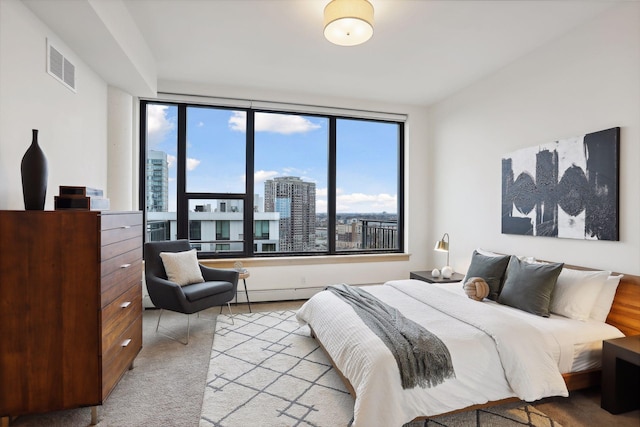 carpeted bedroom featuring multiple windows