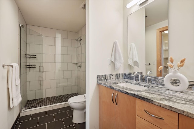 bathroom with toilet, vanity, tile patterned floors, and a shower with door