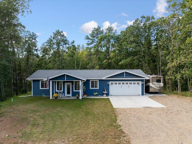 single story home featuring covered porch, a front yard, and a garage