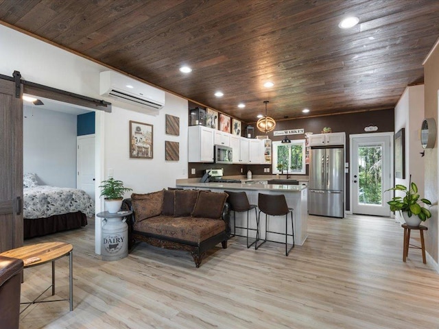 living room with light hardwood / wood-style flooring, a barn door, wooden ceiling, and an AC wall unit