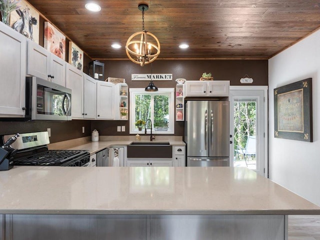 kitchen featuring decorative light fixtures, a notable chandelier, stainless steel appliances, and wooden ceiling