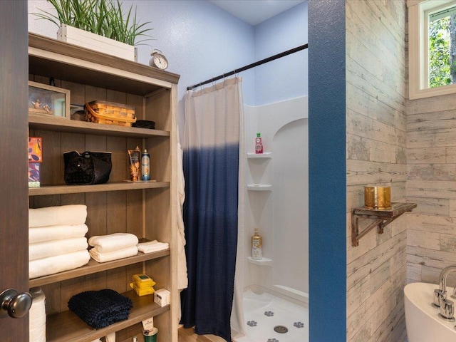 bathroom featuring wood walls and a shower with curtain