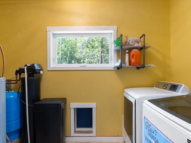 washroom with washing machine and clothes dryer