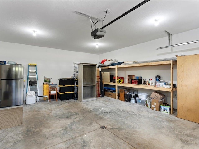 garage featuring stainless steel refrigerator and a garage door opener