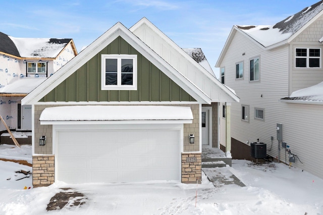 view of front of property with cooling unit and a garage