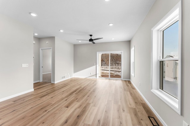 unfurnished living room with ceiling fan and light hardwood / wood-style floors