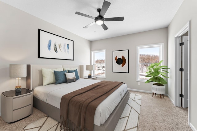 bedroom with ceiling fan and light carpet