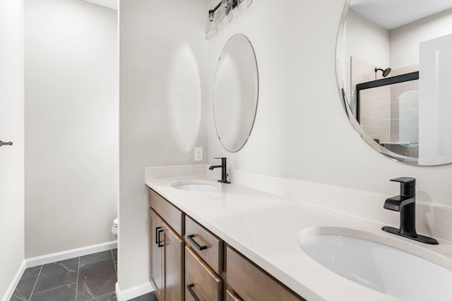 bathroom with a shower with door, vanity, and toilet