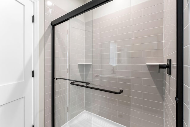 bathroom with a shower with shower door