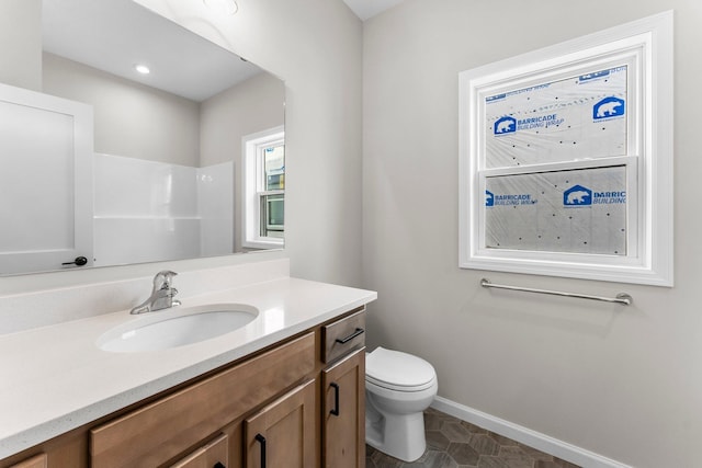 bathroom with tile patterned flooring, vanity, and toilet