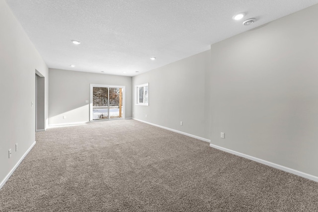 unfurnished living room featuring carpet flooring and a textured ceiling