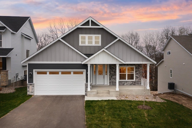 view of front of home featuring a yard, covered porch, and central AC unit