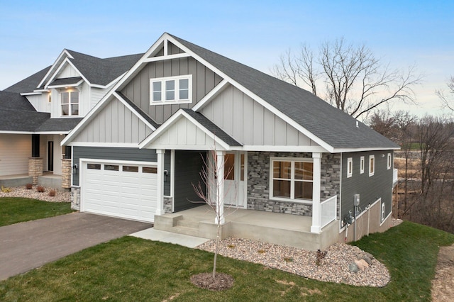 craftsman inspired home with a front yard, a porch, and a garage