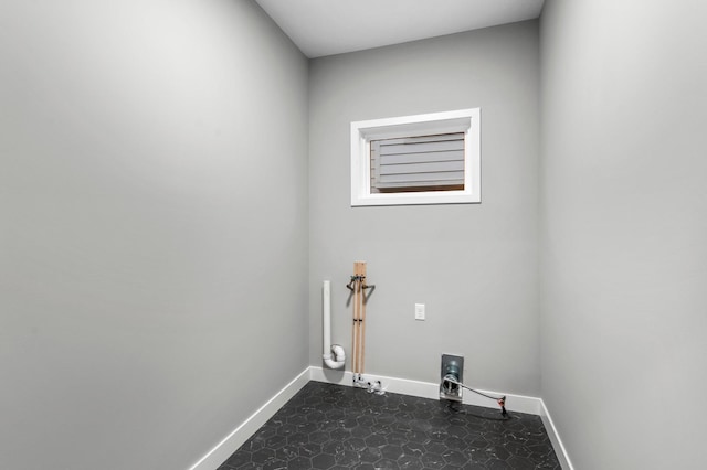 washroom featuring hookup for a gas dryer, washer hookup, and dark tile patterned flooring