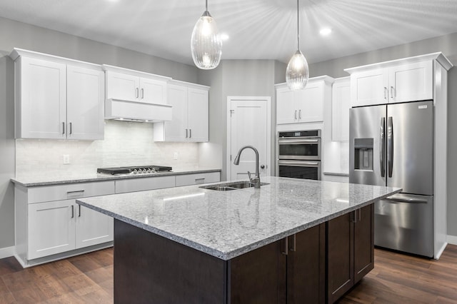 kitchen featuring hanging light fixtures, white cabinetry, sink, and stainless steel appliances