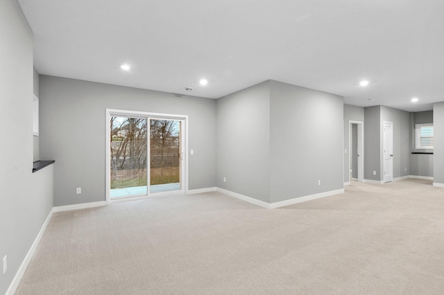 carpeted empty room with plenty of natural light