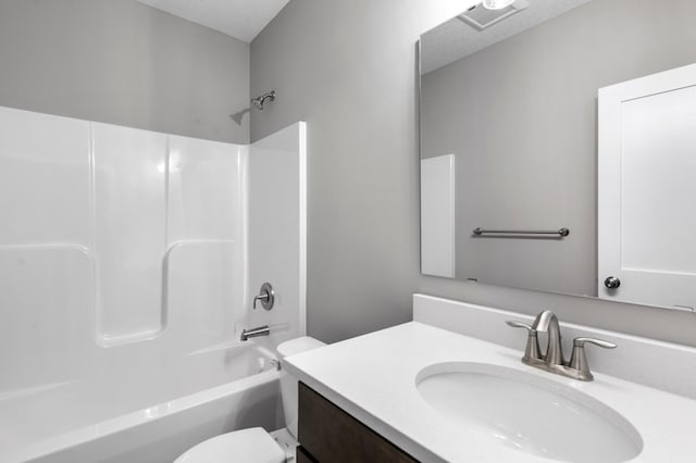 full bathroom featuring shower / bathing tub combination, vanity, toilet, and a textured ceiling