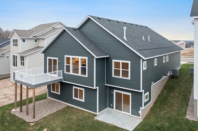 back of house with a yard, a patio, and central air condition unit