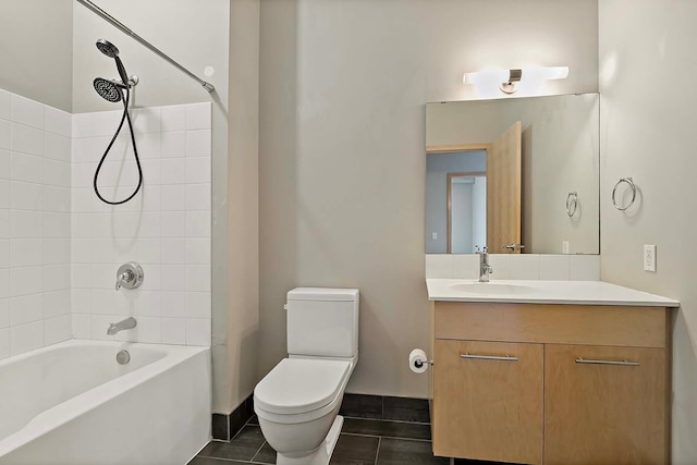 full bathroom with vanity, tiled shower / bath, tile patterned floors, and toilet