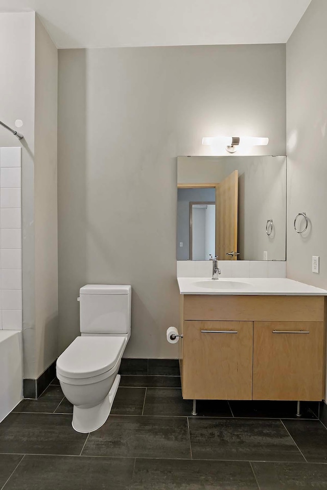 full bathroom featuring vanity, bathtub / shower combination, and toilet