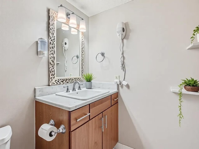 bathroom with toilet and vanity