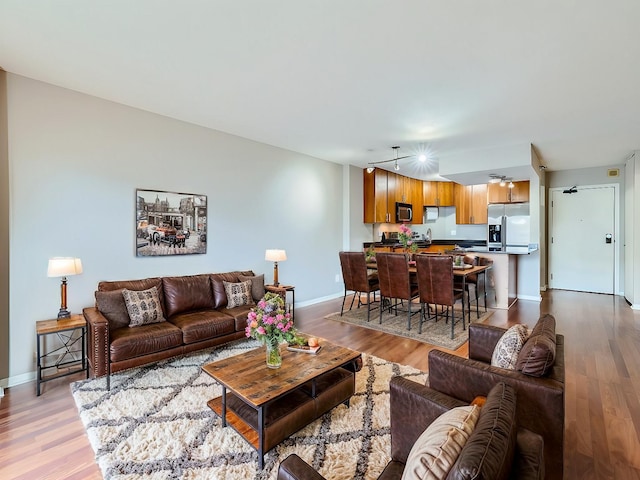 living area featuring wood finished floors and baseboards