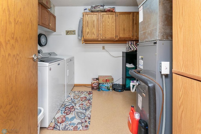 laundry area featuring washer and clothes dryer and cabinets