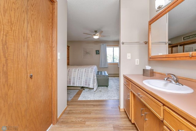 bathroom featuring ceiling fan, hardwood / wood-style flooring, and vanity