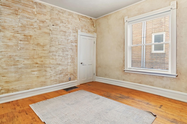 3017 James Ave S, Minneapolis, MN 55408 - spare room with ornamental molding and wood finished floors