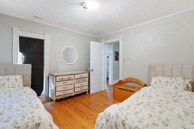 bedroom featuring wood-type flooring and ornamental molding