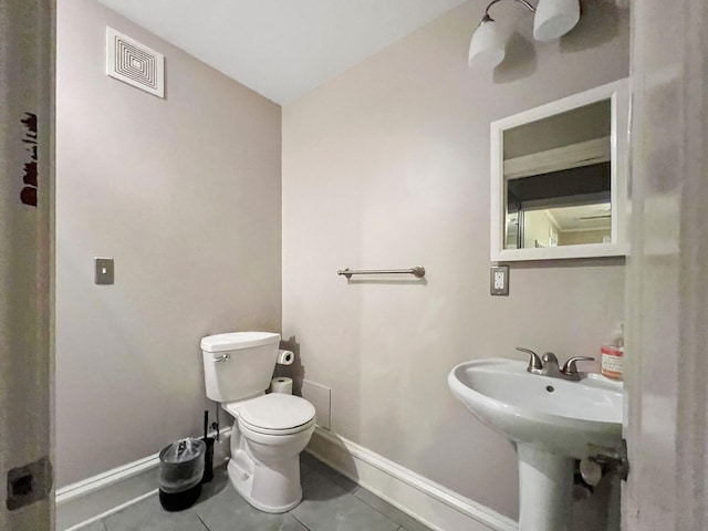 3017 James Ave S, Minneapolis, MN 55408 - half bathroom with toilet and tile patterned flooring